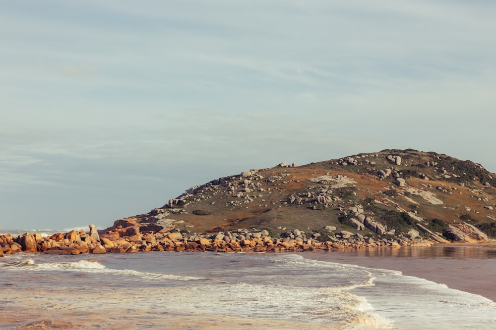 a large rock outcropping next to a body of water