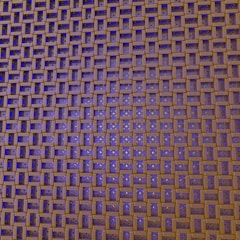An intricate pattern of interlocking wooden blocks creates a geometric grid. The blocks are arranged in a lattice formation, with some gaps revealing a deep blue background beneath. Small white star-like patterns are visible on the blue sections.