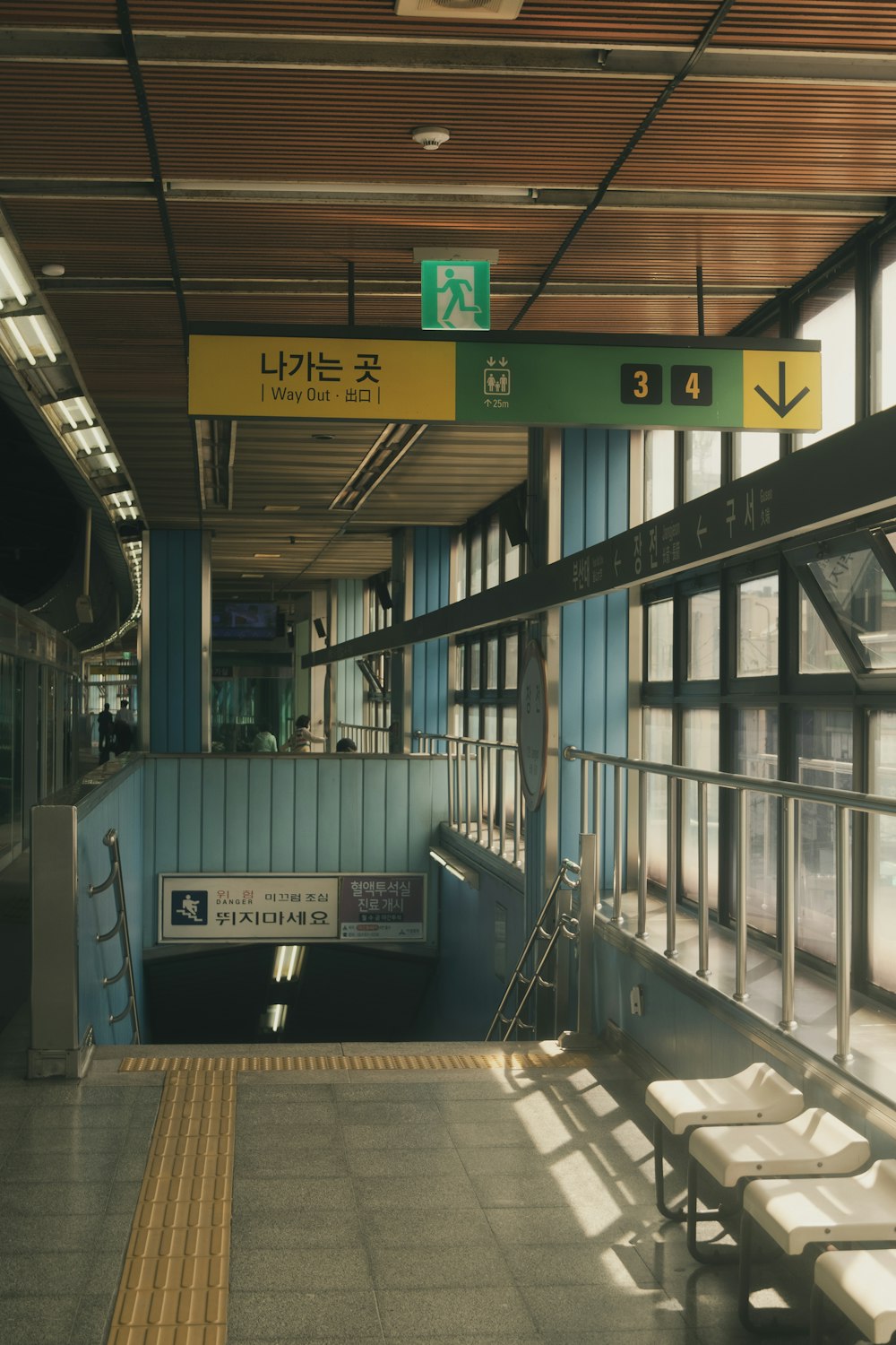 a train station with benches and a sign