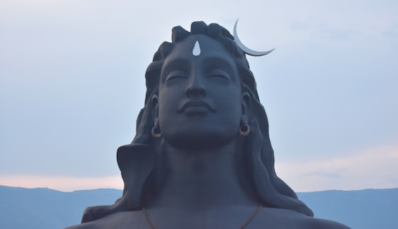 A serene illustration of Lord Shiva meditating under a crescent moon with the Ganges flowing from his hair.