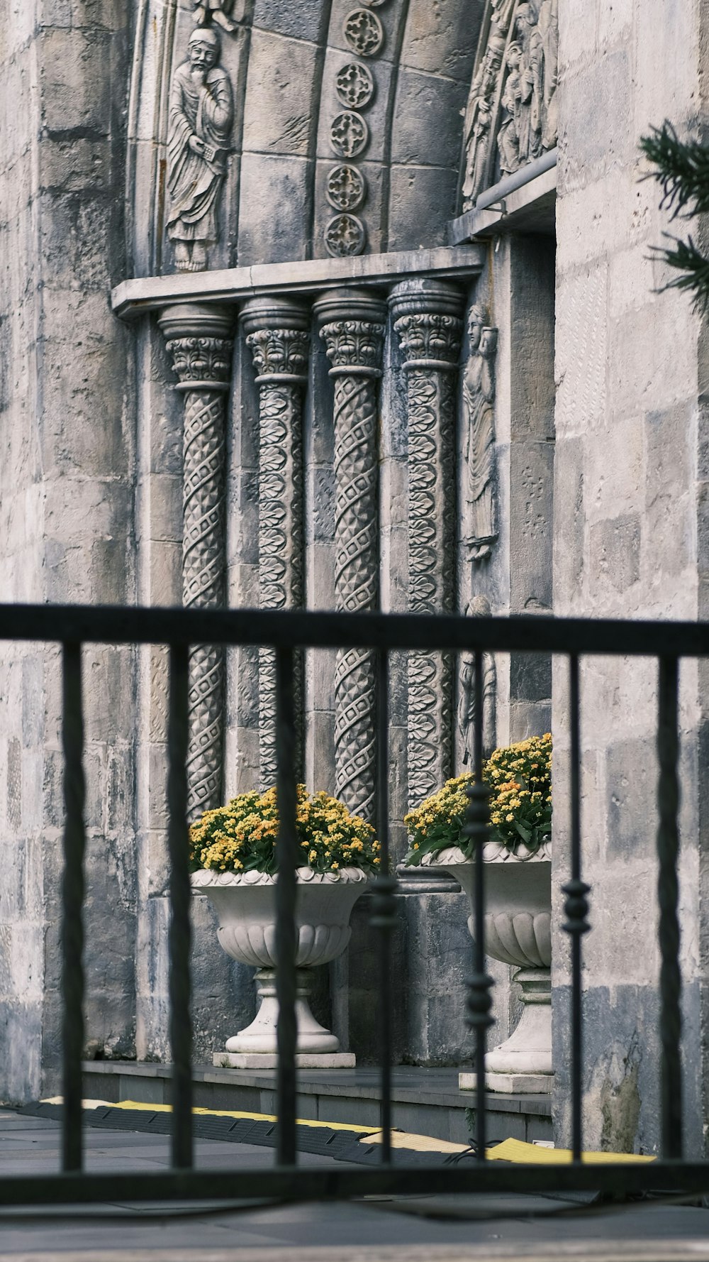 a tall building with a bunch of flowers in front of it