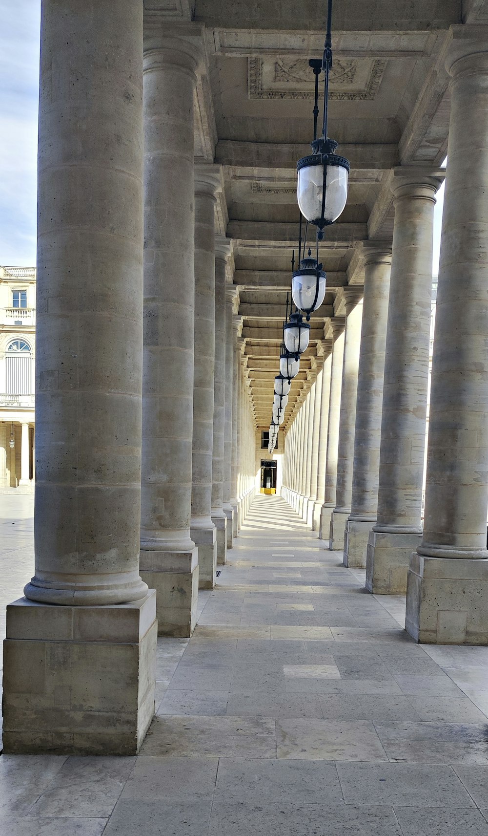 a row of pillars with lamps hanging from them