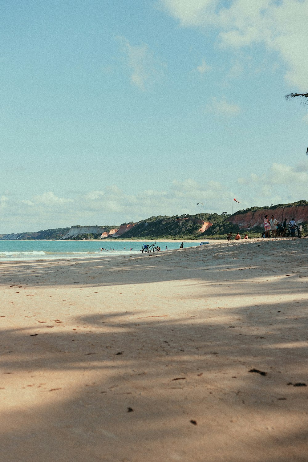 a sandy beach with a few people on it