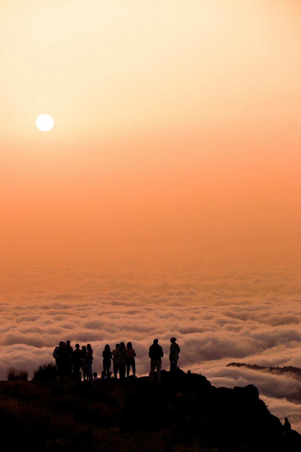 Un grupo de personas de pie en la cima de una montaña