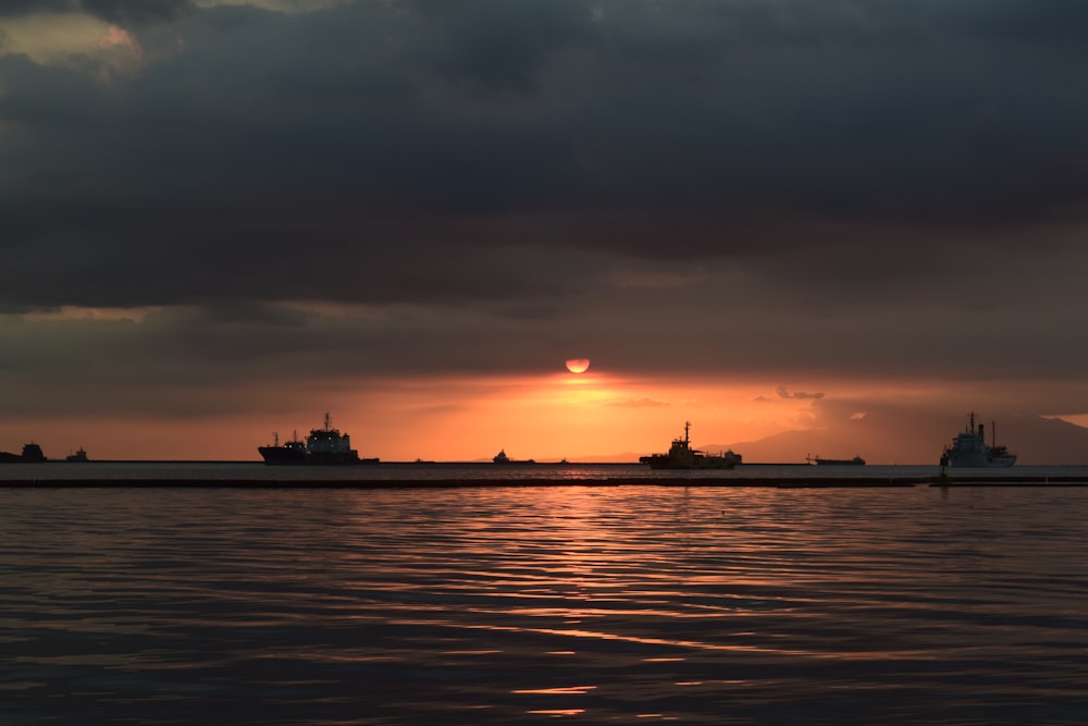 the sun is setting over a large body of water