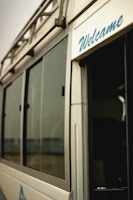 A driver opening the door of a polished vehicle, ready to welcome new passengers for a day trip.