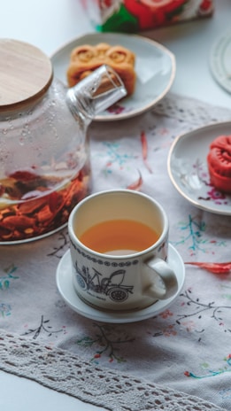 An elegant display of Zi Wei Dou Shu star charts laid out on a wooden table with a cup of tea nearby.