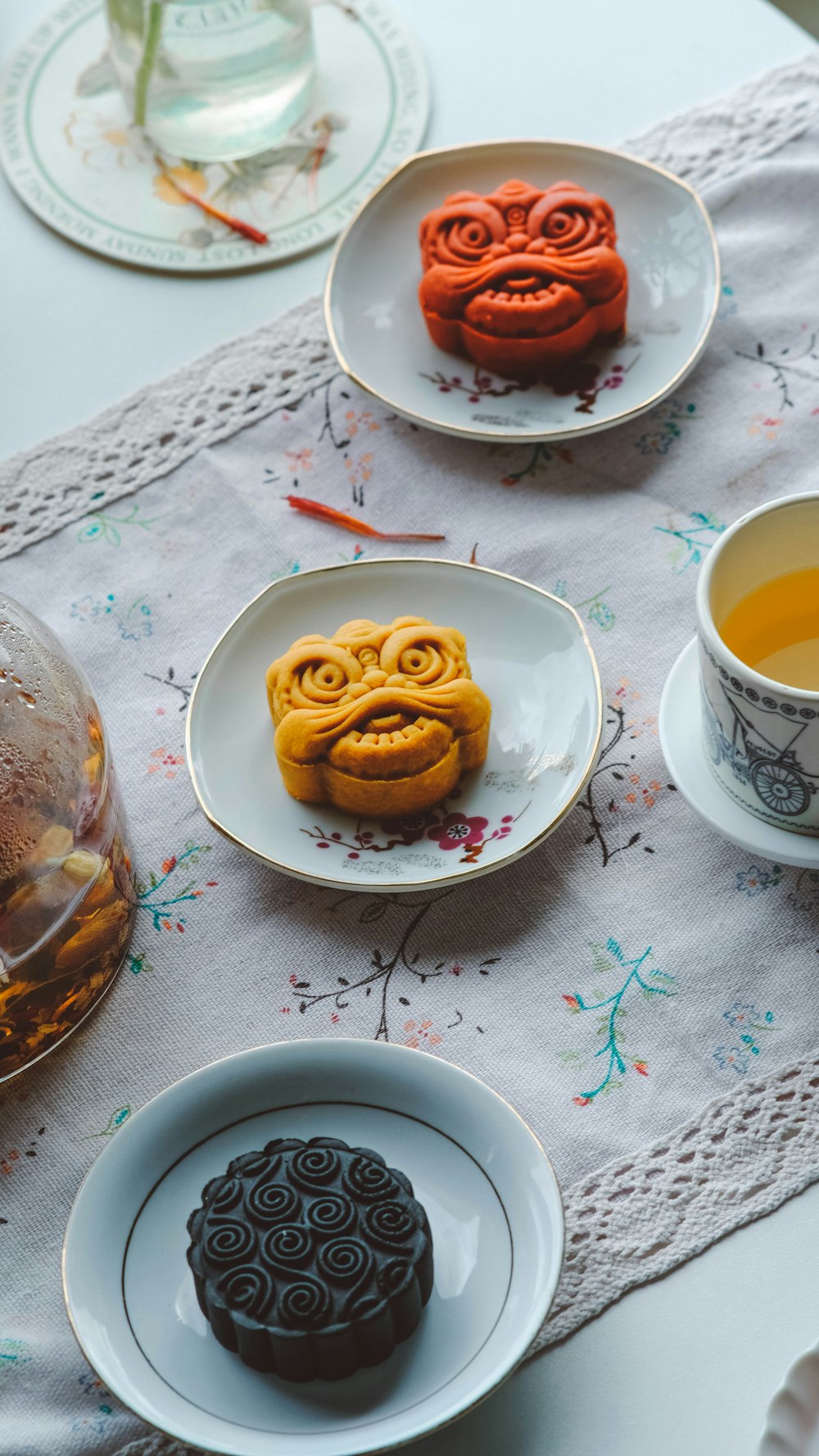 a table topped with plates of food and cups of tea