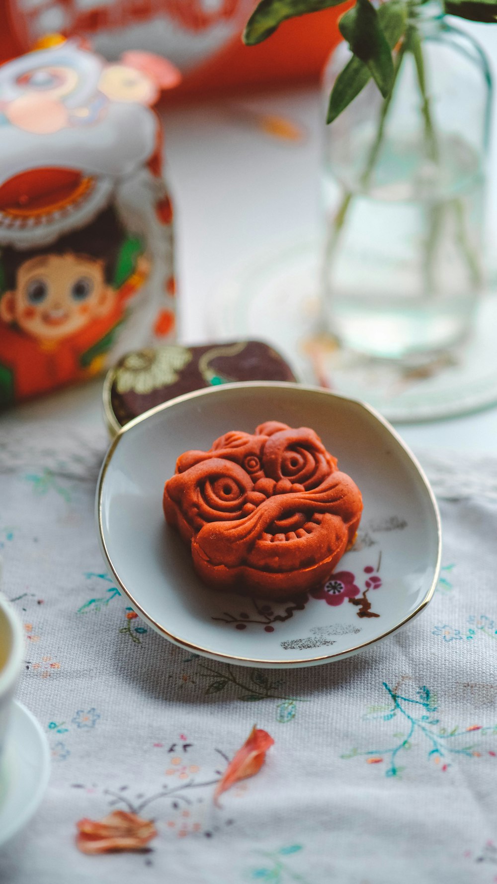 a white plate topped with red cookies on top of a table