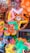 A vibrant display of various Halloween costumes and accessories on a colorful backdrop.