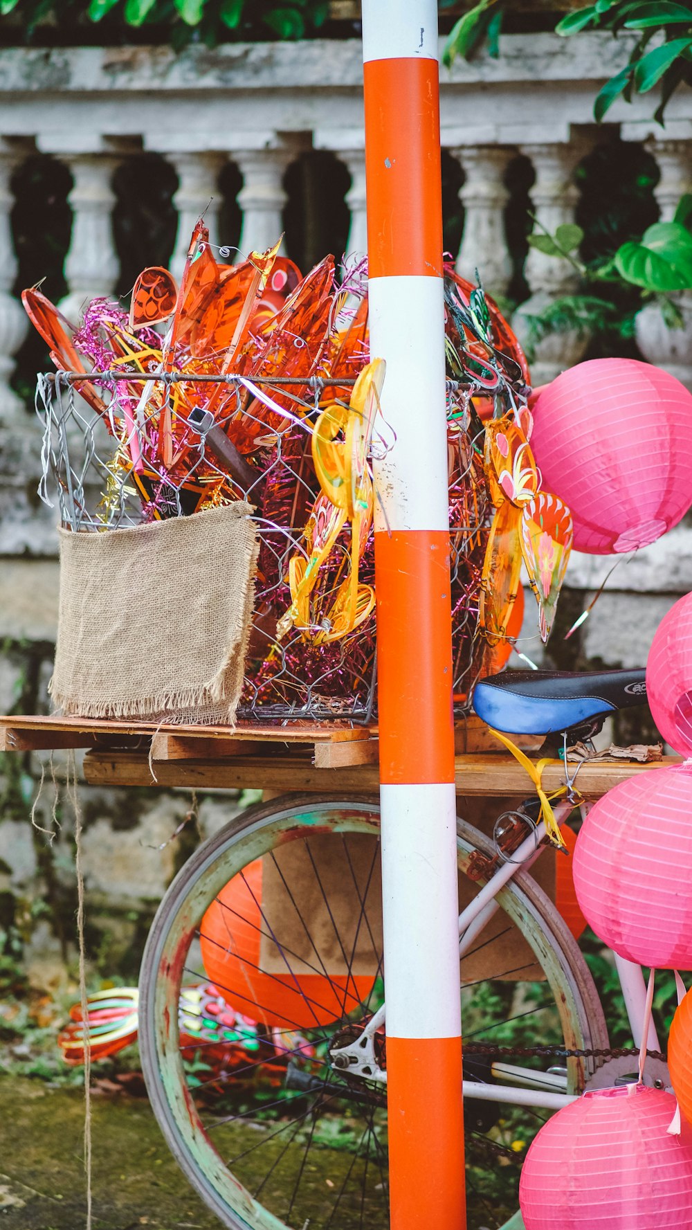 a bicycle parked next to a table with a basket on top of it