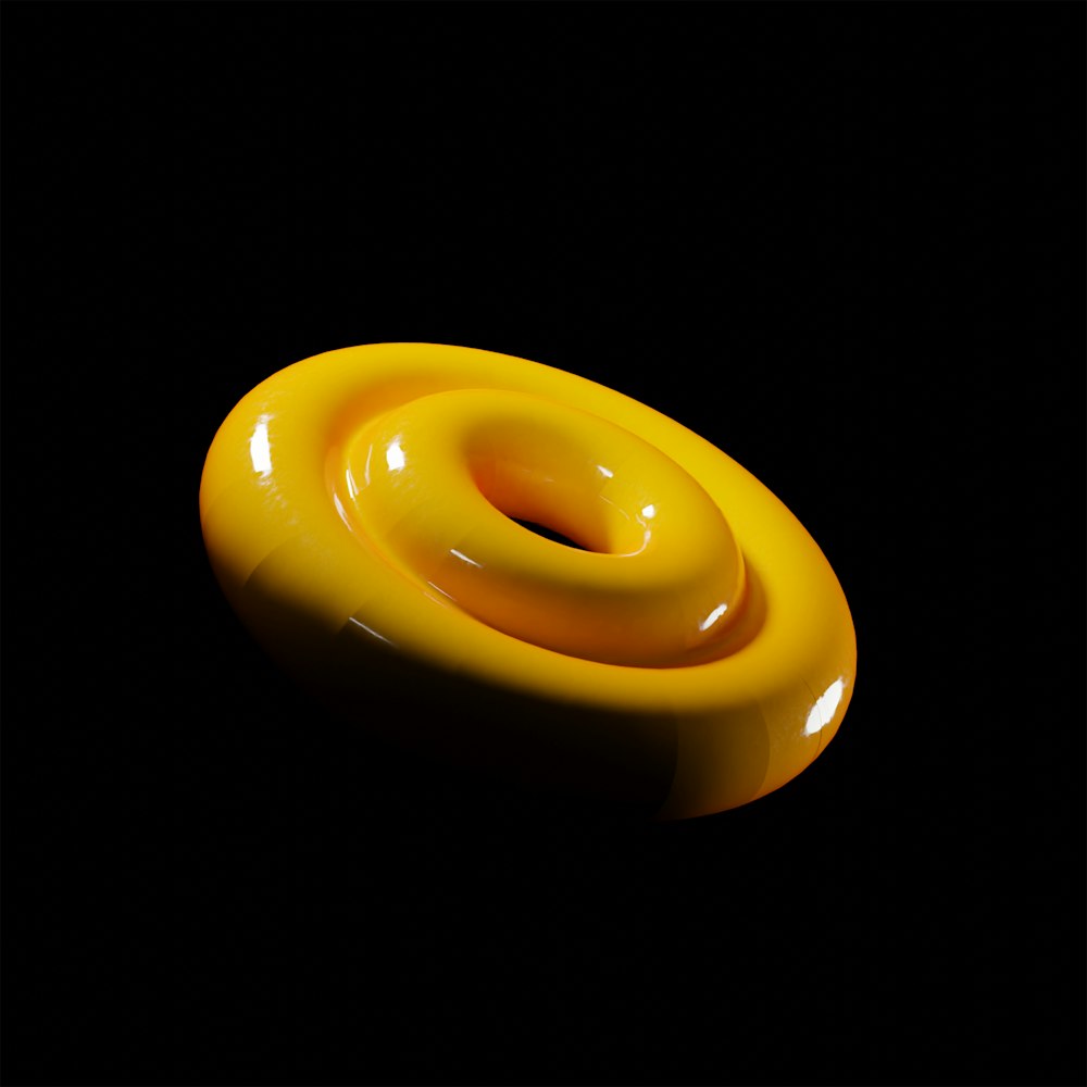 a yellow object sitting on top of a black surface