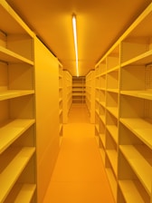 a long row of shelves in a yellow room