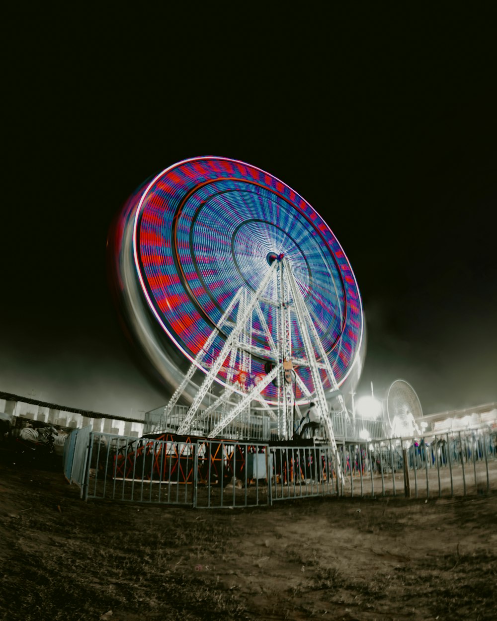 a ferris wheel in a carnival park at night