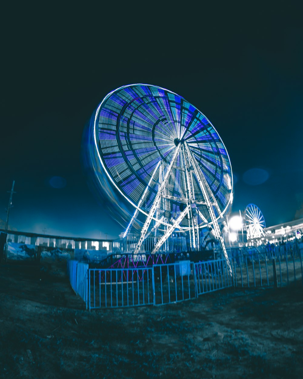 a ferris wheel is lit up at night