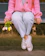 a woman sitting on a bench holding flowers
