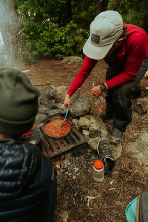 a man cooking food over an open fire