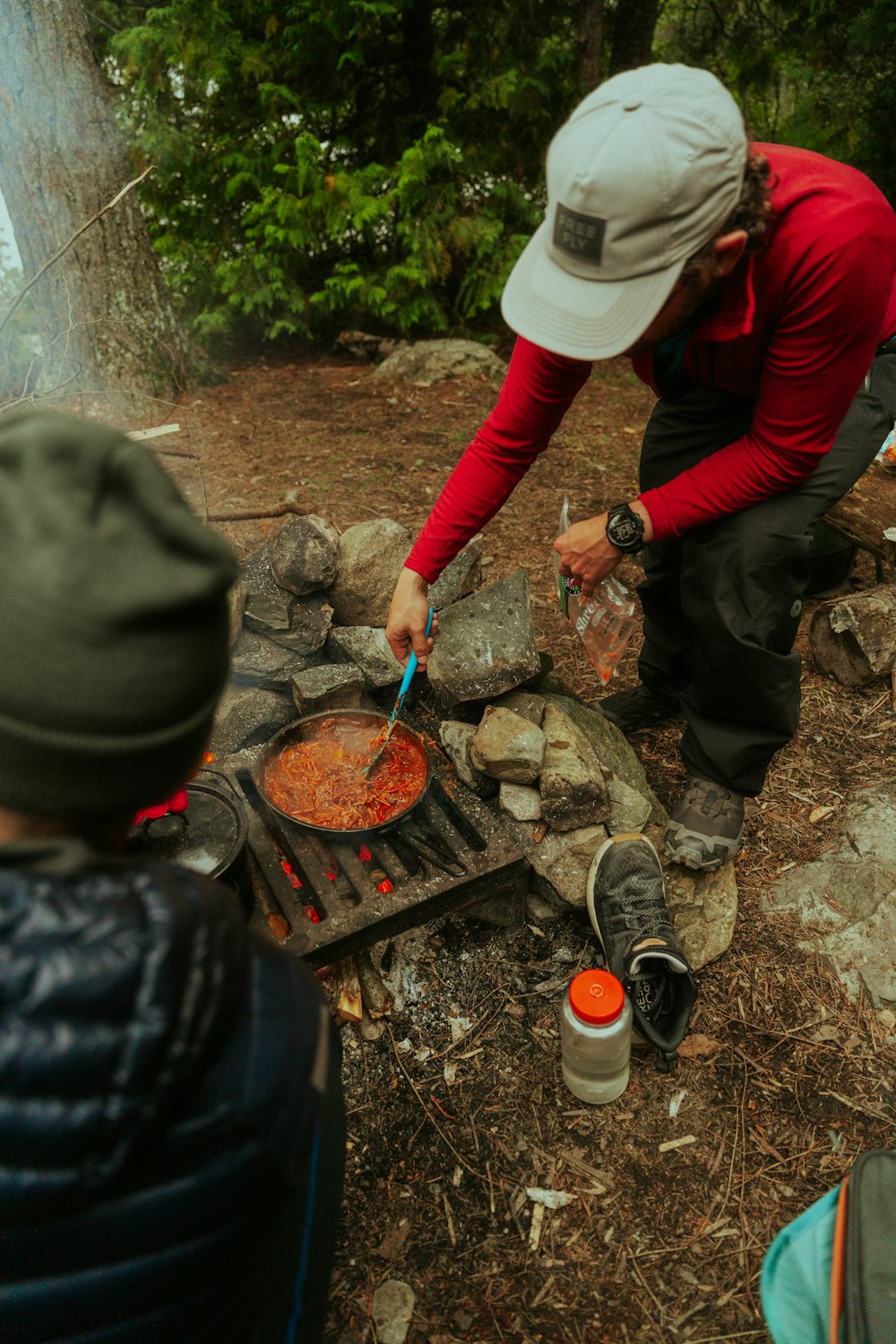 a man cooking food over an open fire