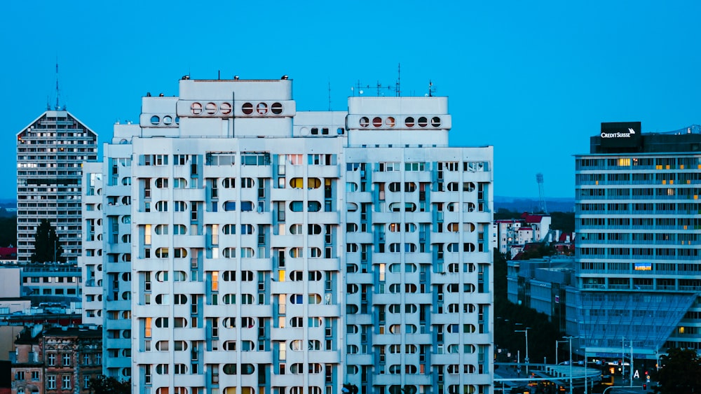 a tall white building with lots of windows