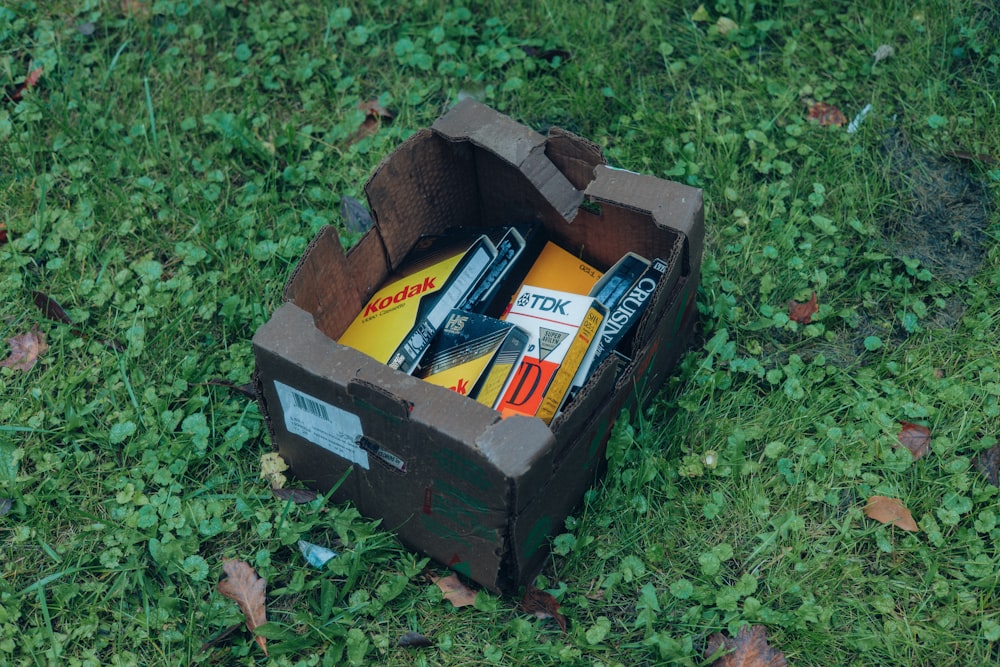 a box filled with tools sitting on top of a lush green field