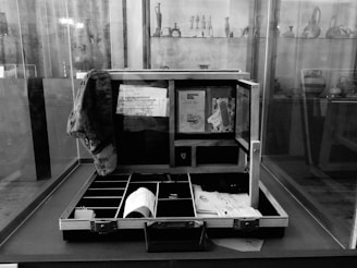 A professional lawyer's briefcase partially open showing legal papers inside.