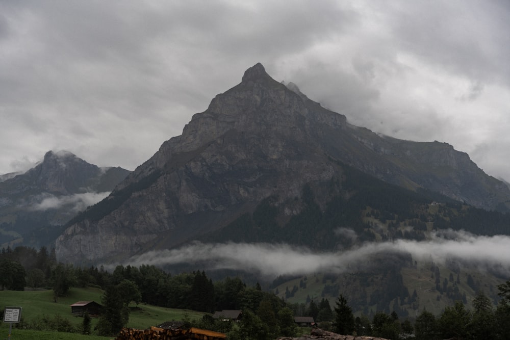 a mountain covered in fog and clouds in the distance