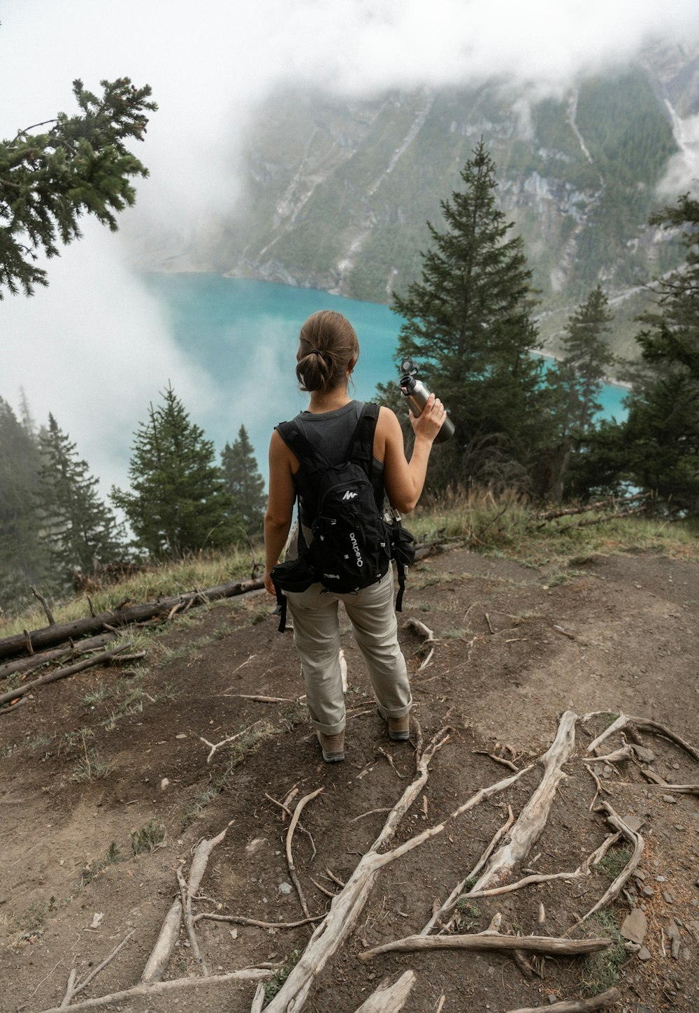 a person standing on a hill with a backpack