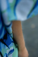 Close-up of a handblocked organic cotton shirt with bold, abstract patterns in vibrant colors.