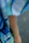 Close-up of a man wearing a vivid, finely crafted t-shirt with a cozy, colorful background.