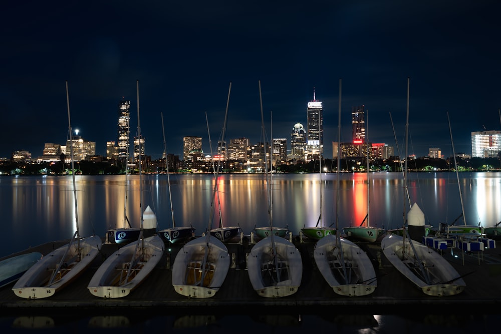 a row of boats sitting on top of a pier