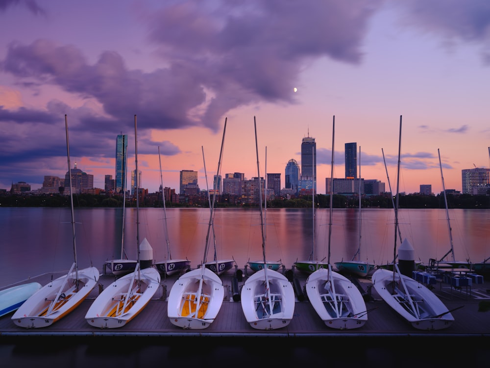 a row of boats sitting on top of a pier