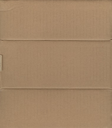 A brown cardboard box, closed and laid flat, with visible creases and slight shadows indicating the box's structure with its intersecting flaps.
