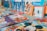 An assortment of colorful children's books arranged on a surface. The books feature popular animated characters and themes, with prominent illustrations on their covers.