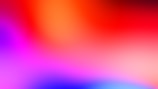 A vibrant blend of colors creating an abstract gradient. Warm hues like red and orange mingle with cooler tones of purple, pink, and blue, forming a fluid and seamless color transition.