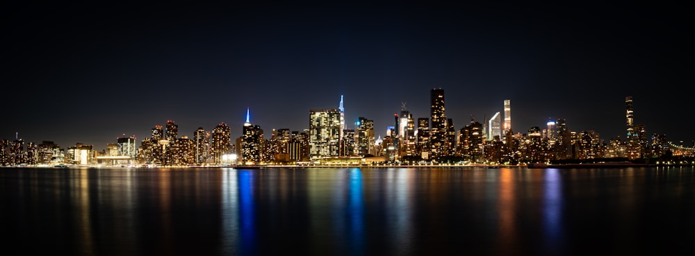 a city skyline is lit up at night
