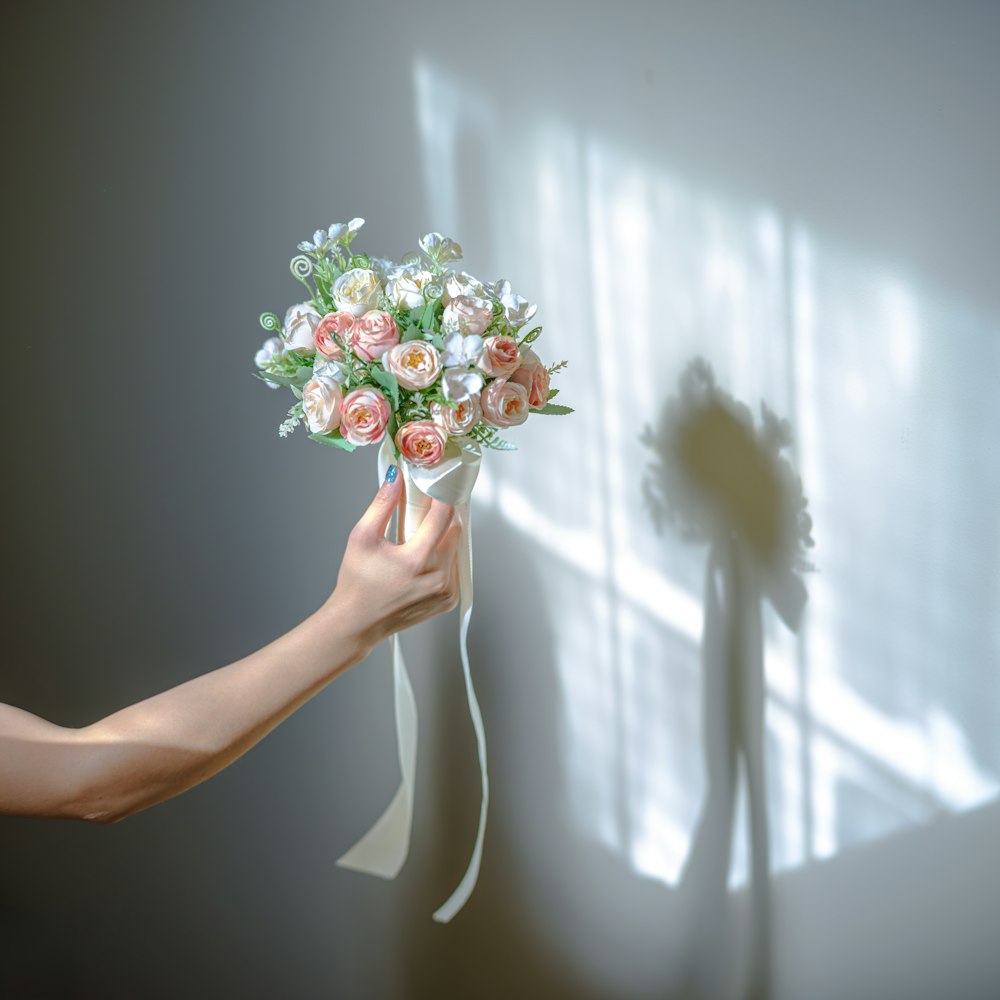 a person holding a bouquet of flowers in their hand