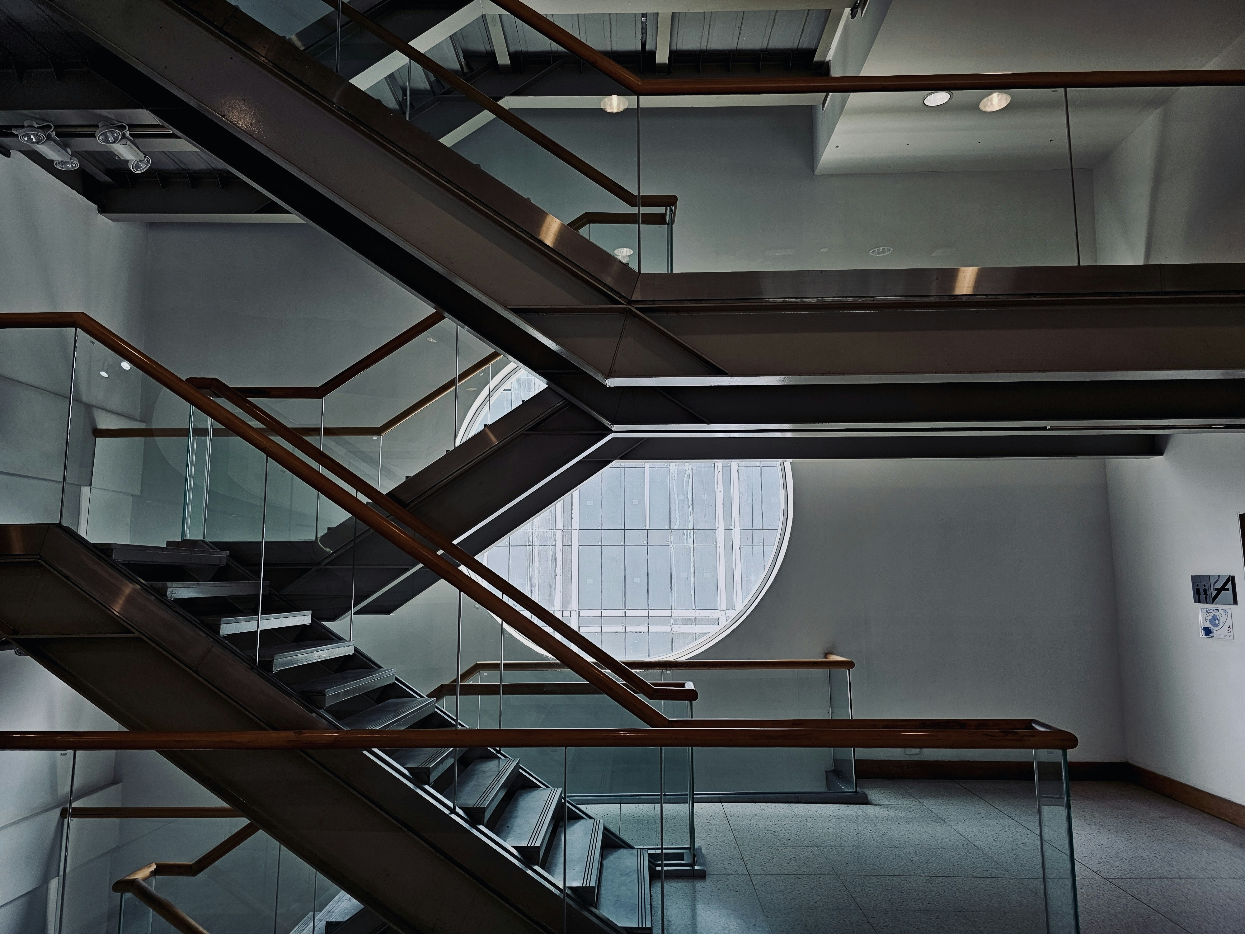 a set of stairs in a building with glass railings