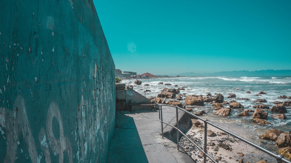 a view of the ocean from a concrete wall