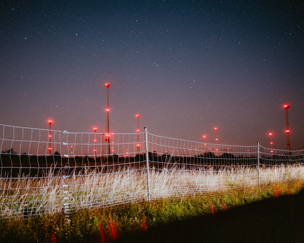 a fence that has some red lights on it