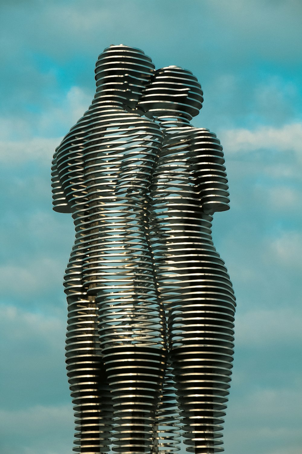 a sculpture of two people standing next to each other