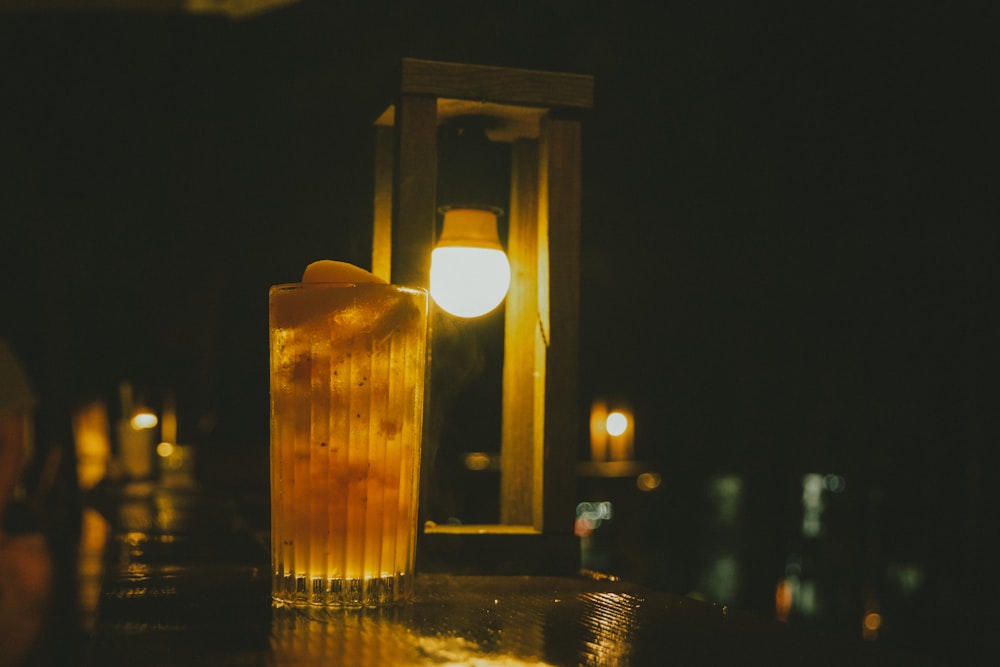 a tall glass filled with liquid sitting on a table