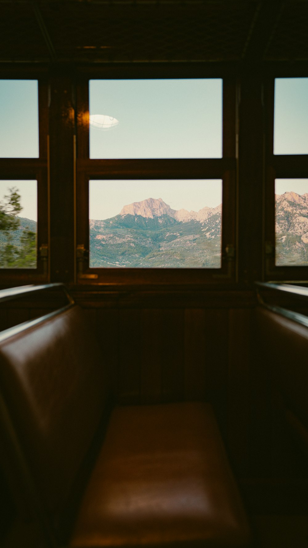 a bench sitting in front of two windows