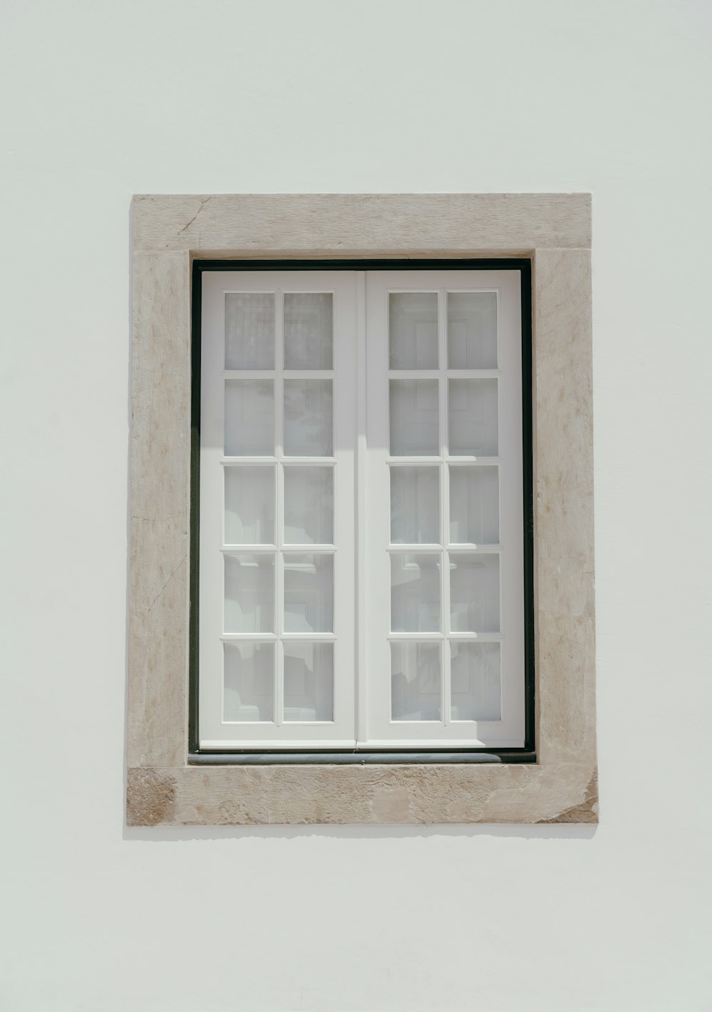 a window with a white frame and black trim