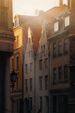 A bustling city street flanked by historic buildings bathed in warm golden light.