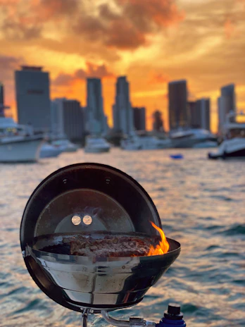 A sleek, modern Grill Master Chef™ barbecue set up on a balcony with city view.