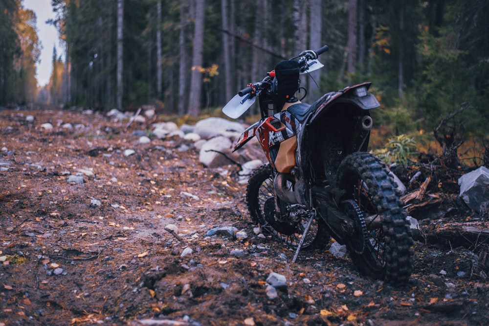 a dirt bike parked on the side of a dirt road