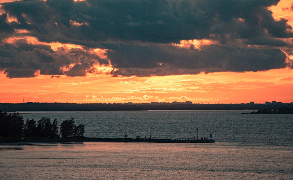 a large body of water under a cloudy sky