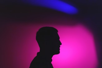 a silhouette of a man in a dark room