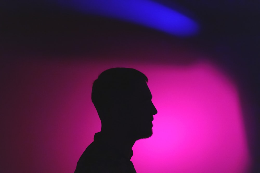 a silhouette of a man in a dark room