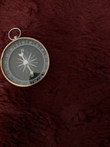 A close-up of a compass resting on a map, symbolizing direction and adventure.